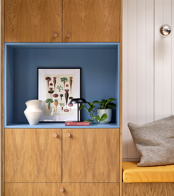 Bespoke unit by the garden access showing a large Blue niche, wooden drawers and doors. 