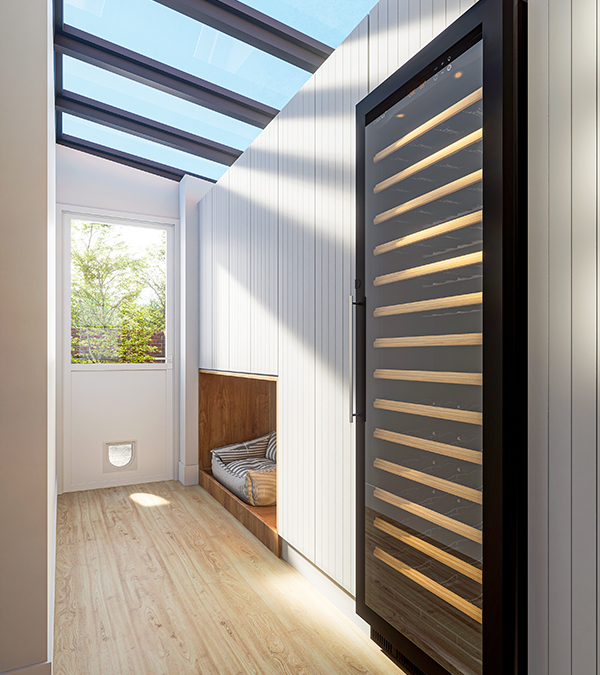 A bright pantry with bespoke storage, a wine fridge, and a cosy pet sleeping area with garden access.